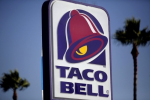 Signage is displayed outside of a Taco Bell restaurant, a unit of Yum! Brands Inc., in Redondo Beach, California, on October 4, 2013.