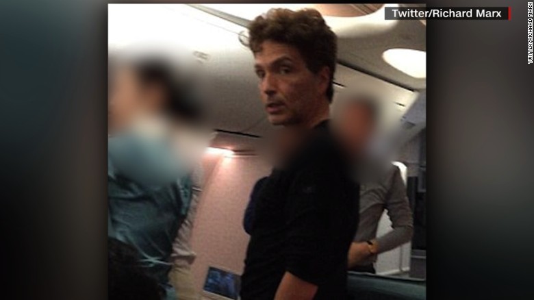 Singer helps restrain violent plane passenger